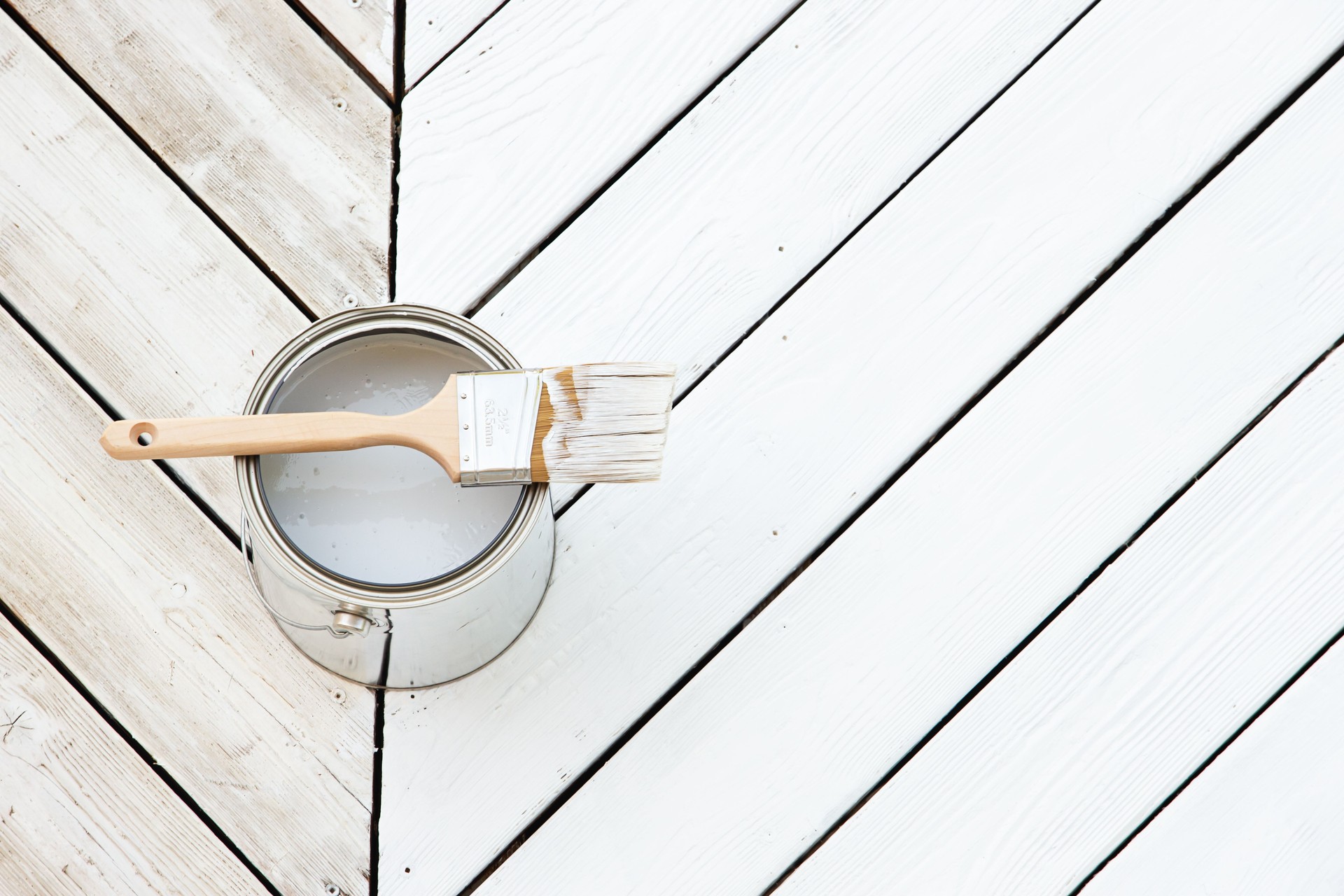 Paint brush over white chevron patio deck